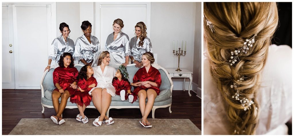 Bridal party in silk robes smiling with the bride and blonde braid with pearl floral hair pieces at the The White Room in St. Augustine, Florida. Photography by Captured By Lau Photography, a St. Augustine, Florida Wedding Photographer.