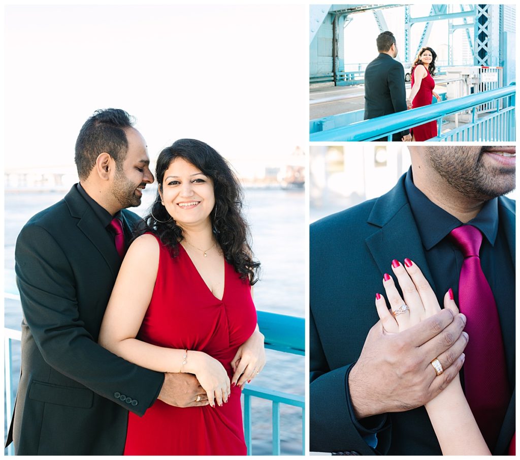 A man in a black suit hugs his soon-to-be wife from behind on a bridge overlooking the water in Jacksonville, Florida.