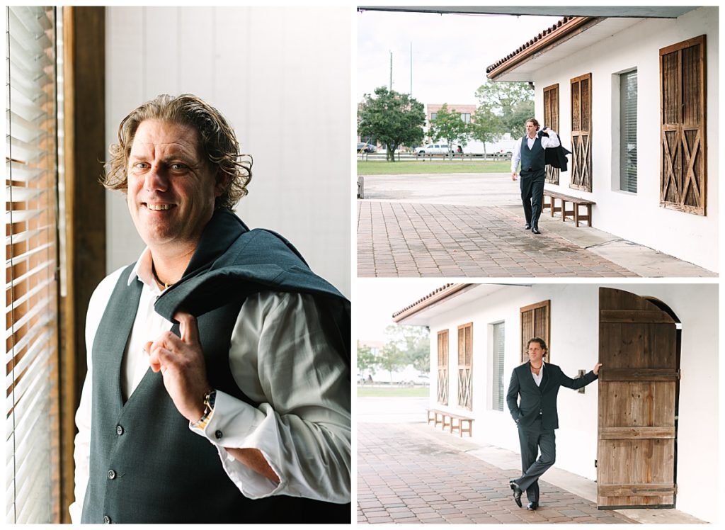 A groom poses next to a window at The Carriage House wedding venue with his black tux jacket draped over his shoulder. 