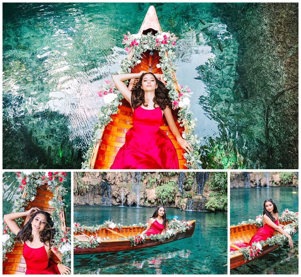 A young woman in a red gown poses in a gondola style boat in a lagoon for her quince session at Secret Gardens Miami taken by Laura Perez Photography.