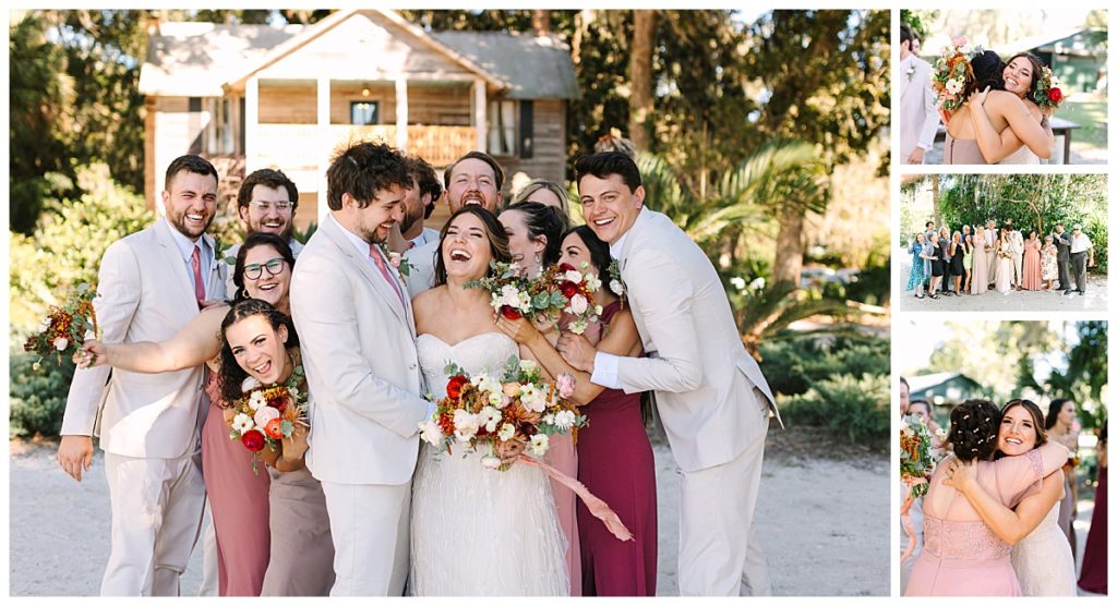 A bride and groom with their wedding party wearing various shades of dusty pink and maroon laugh in front of La Venture Grove wedding venue. 