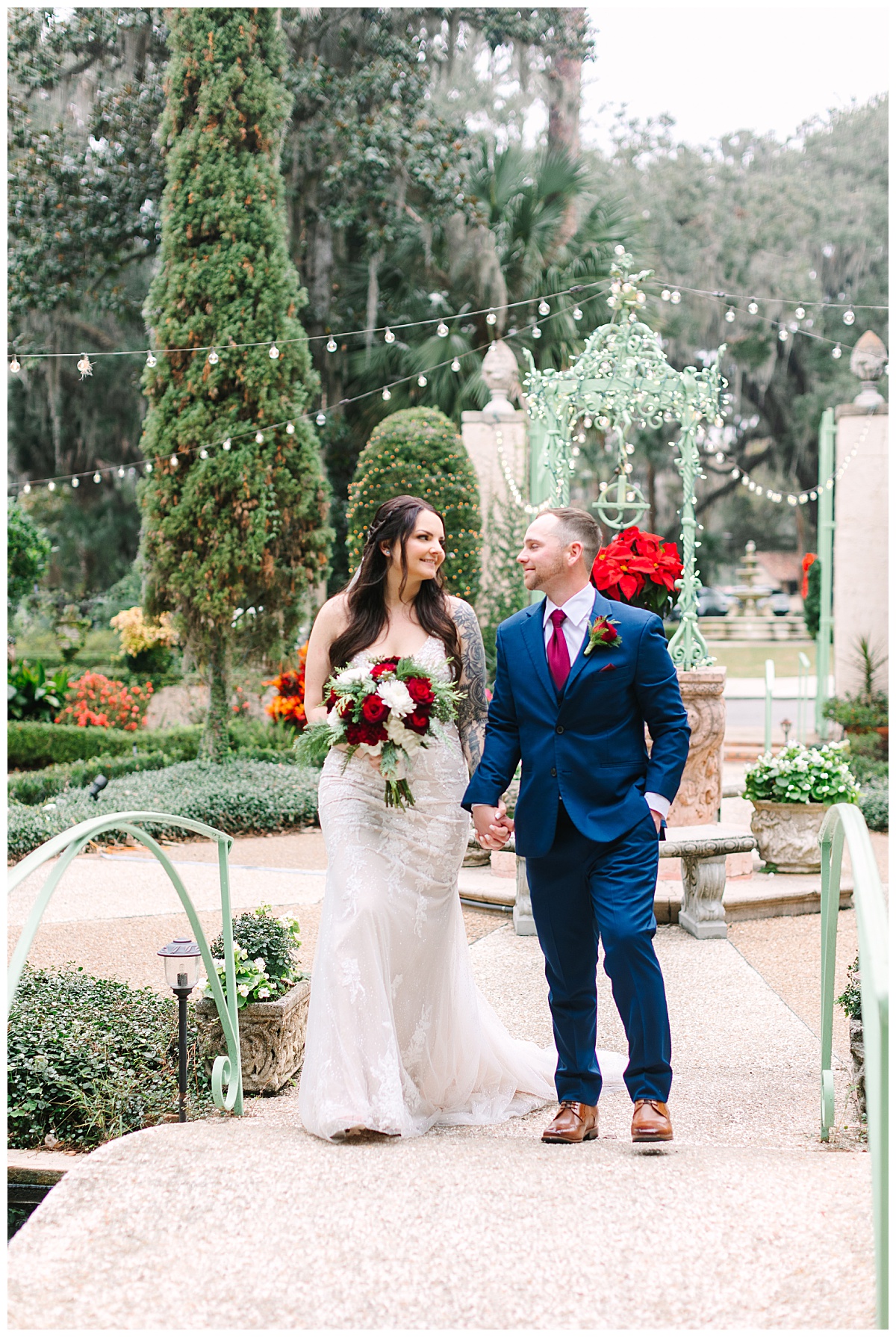A bride and groom stroll hand-in-hand on the grounds of their Florida wedding venue.