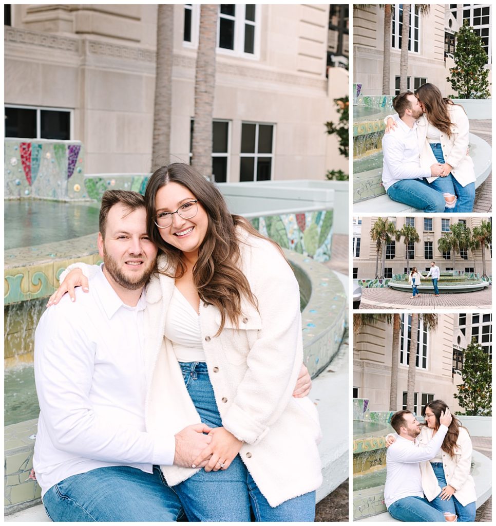 A brunette couple wearing white shirts and jeans embrace, hold hands, and kiss  seated next to a fountain during their engagement photos in Jacksonville, FL.
