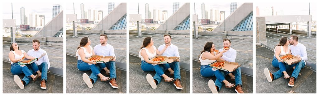 A couple wearing jeans and white shirts enjoy pizza and laughter during their downtown Jacksonville engagement session.