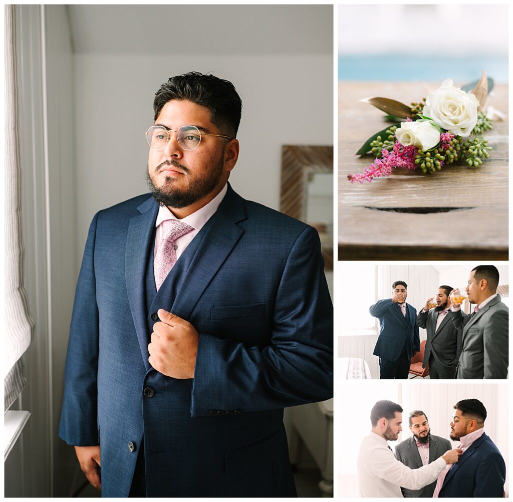A groom in a navy suit with a pink tie prepares for his St. Augustine wedding with his groomsmen. 