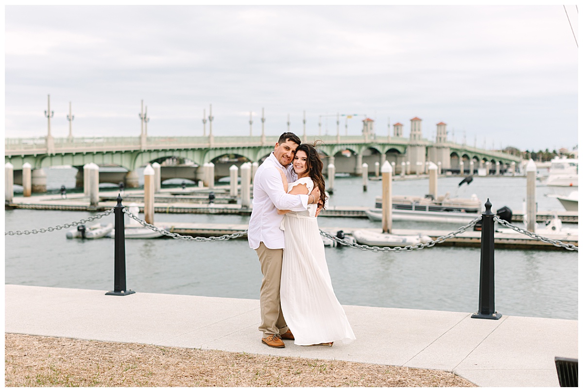 Florida newlyweds embrace at a St. Augustine marina following their romantic beach elopement ceremony.