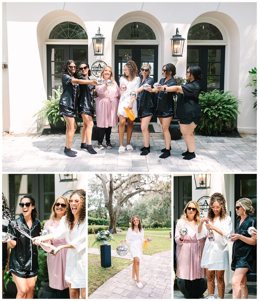 A Florida bride with cascading ringlets and her bridesmaids celebrate her wedding day in satin robes and a bottle of champagne outside the wedding venue.