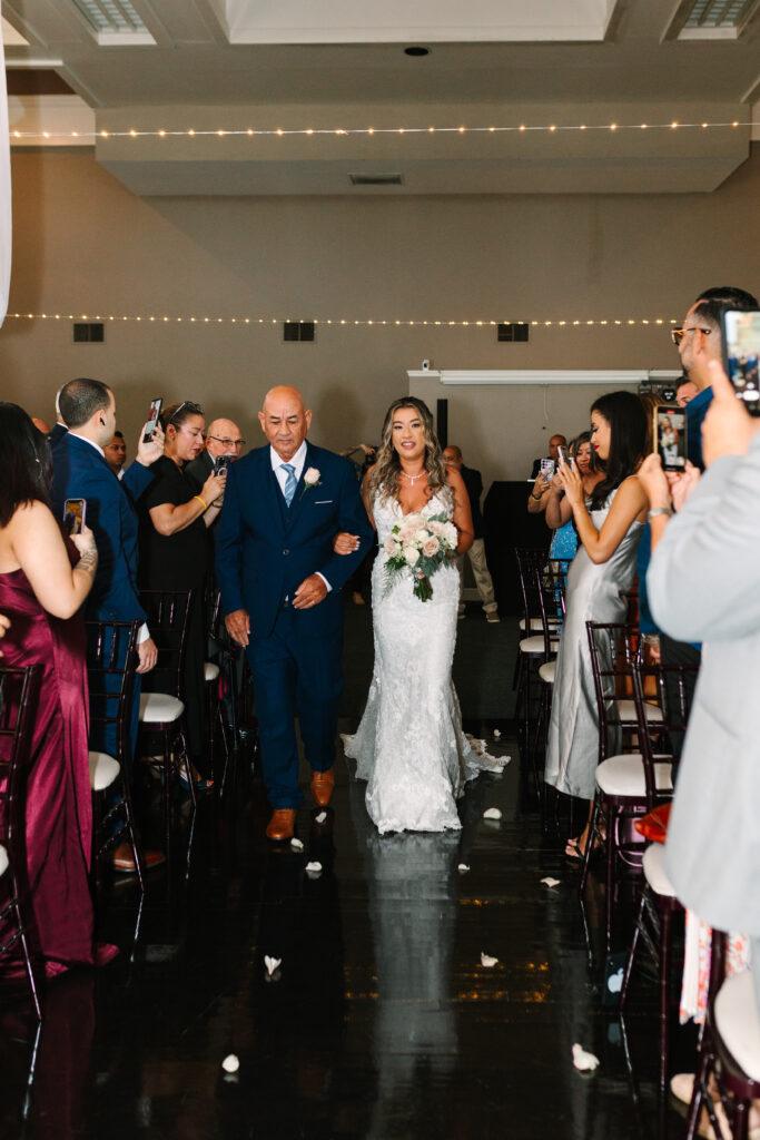 JACKSONVILLE WEDDING PHOTOGRAPHER 
INDOOR CEREMONY IN CHANNEL SIDE PALM COAST WEDDING 
FATHER OF THE BRIDE WALKING HER DOWN THE AISLE.