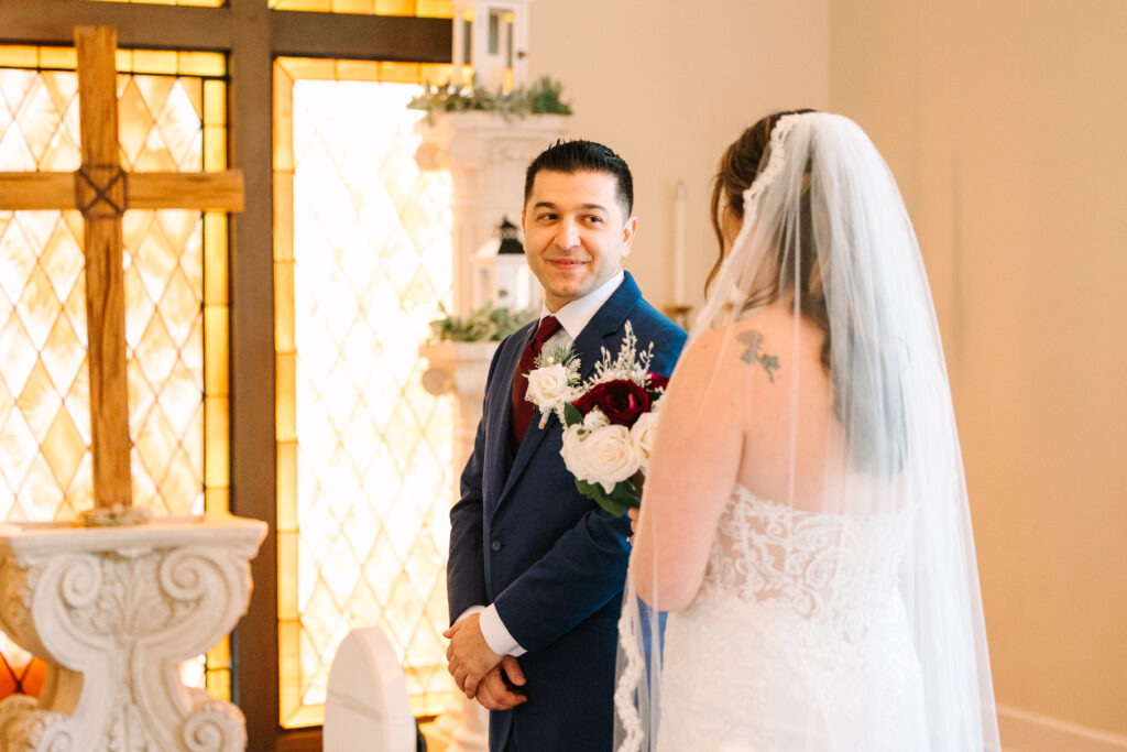 bride and groom first look in the chapel at the lightner museum located in the heart of St. Augustine Florida taken by Laura Perez Photography a Jacksonville wedding photographer