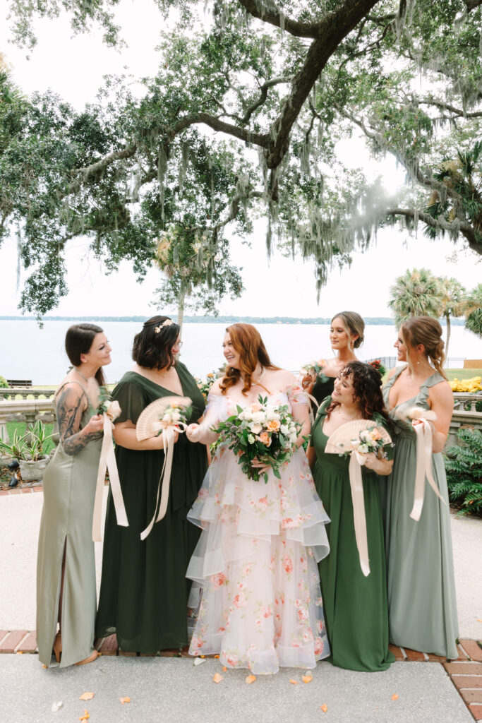 legant riverfront wedding at The Club Continental in Jacksonville, Florida, featuring a couple in the garden surrounded by Spanish-style architecture and lush greenery