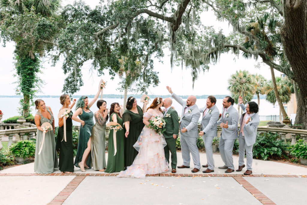 legant riverfront wedding at The Club Continental in Jacksonville, Florida, featuring a couple in the garden surrounded by Spanish-style architecture and lush greenery