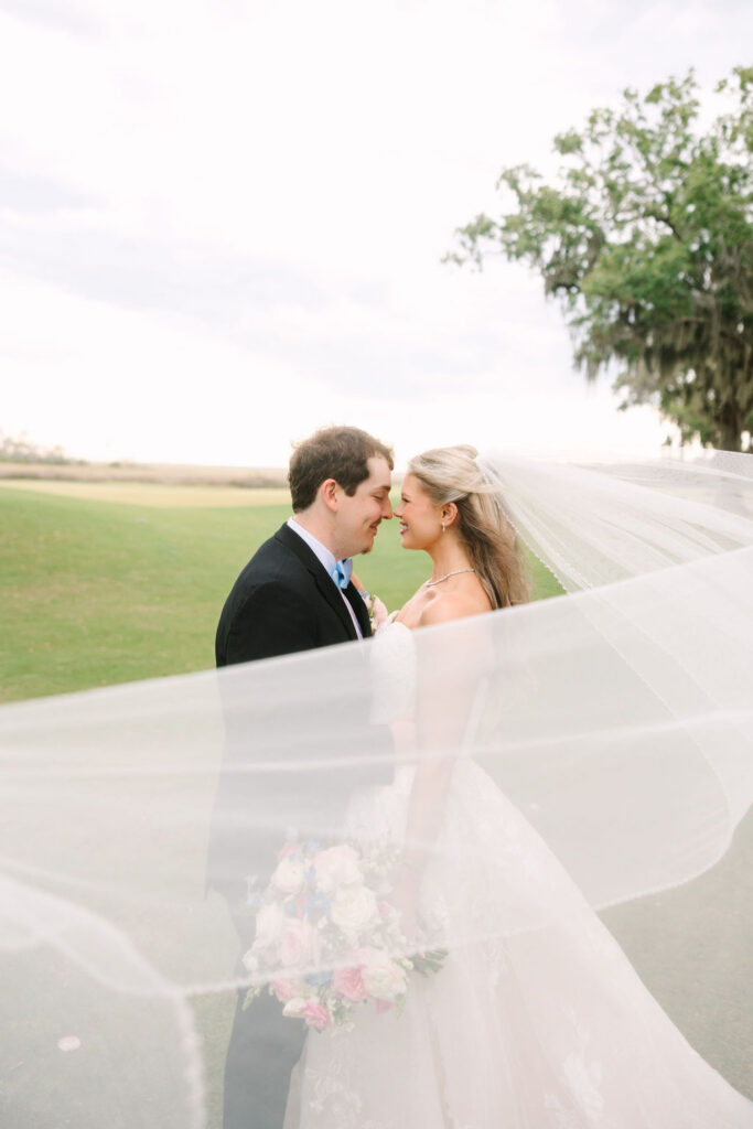 Bride and groom posing together inside The Oaks at Amelia Island wedding venue before their ceremony.