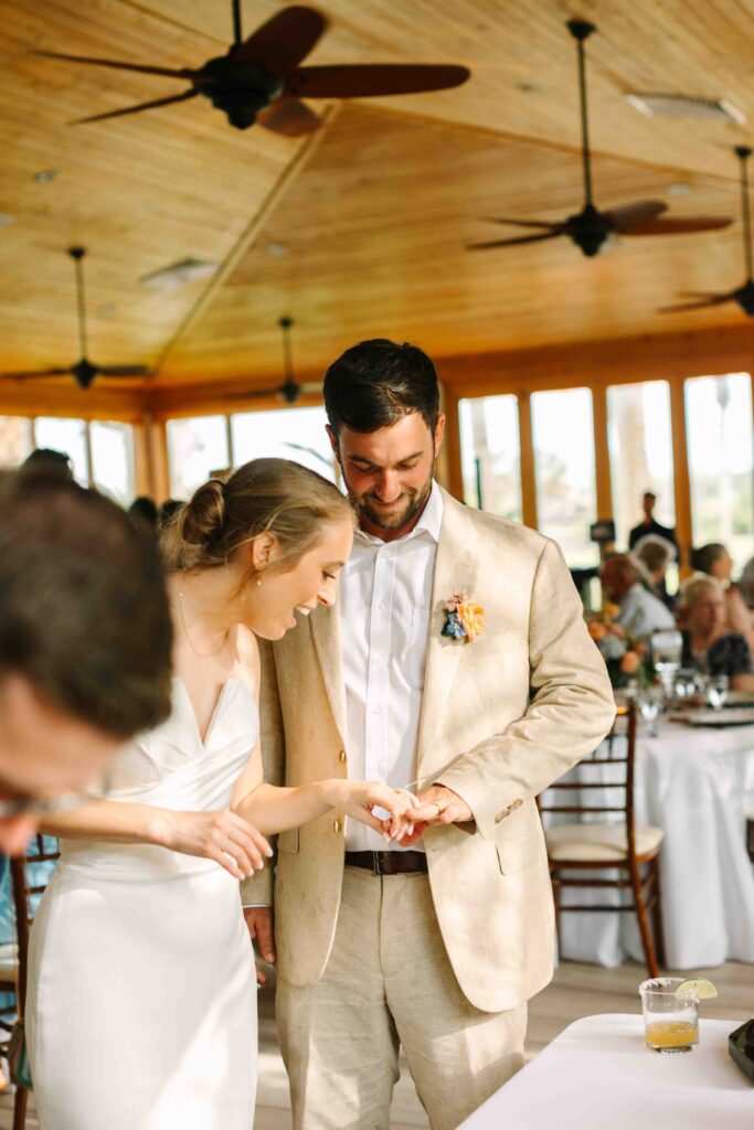 bride and groom looking at ring