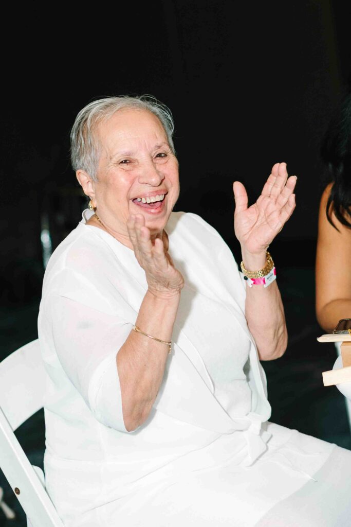 all white party grandmother clapping as bride and groom come in at the riviera maya hard rock resort